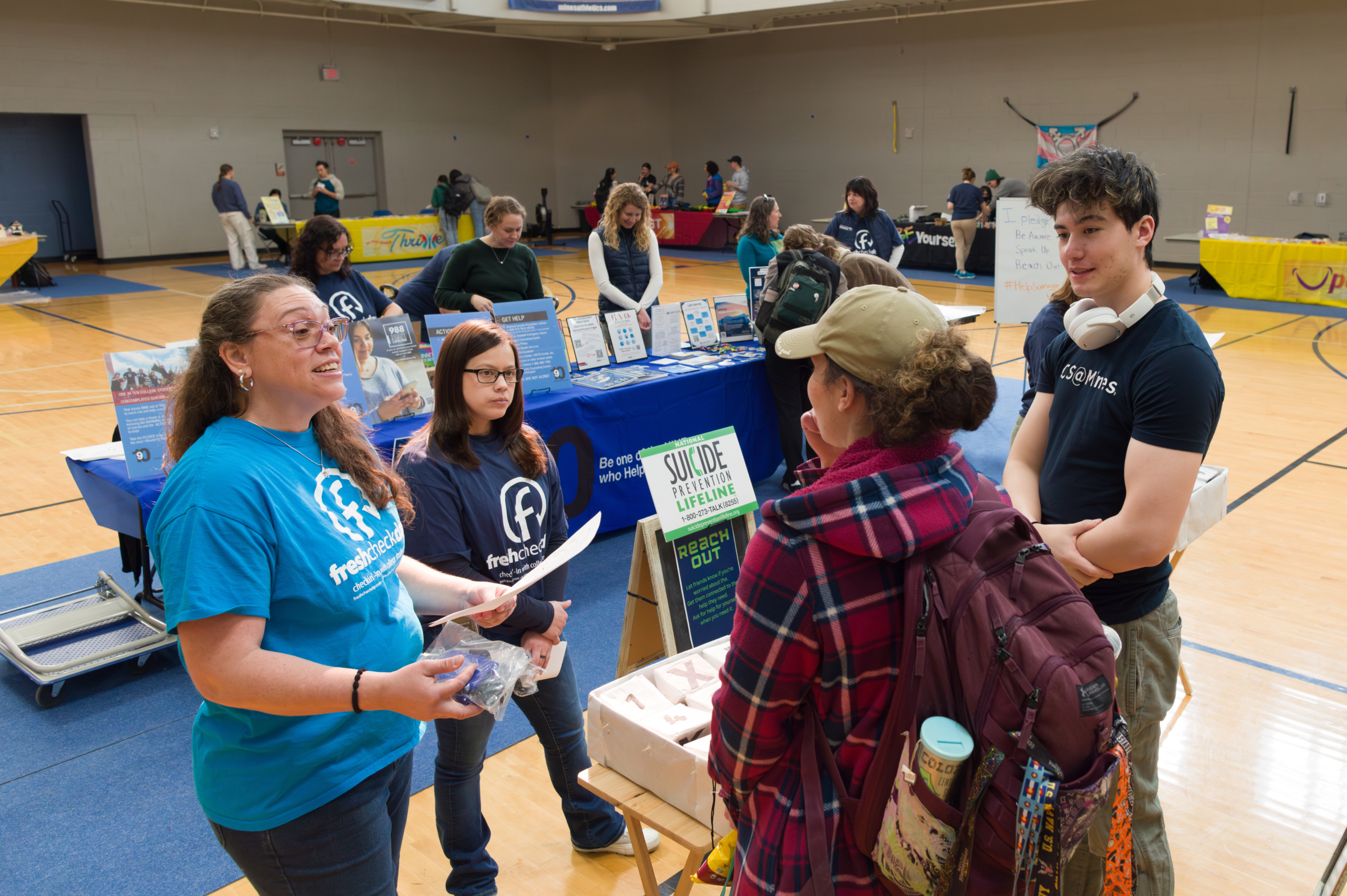 Counseling center staff share information with two students during Mines' Fresh Check Day